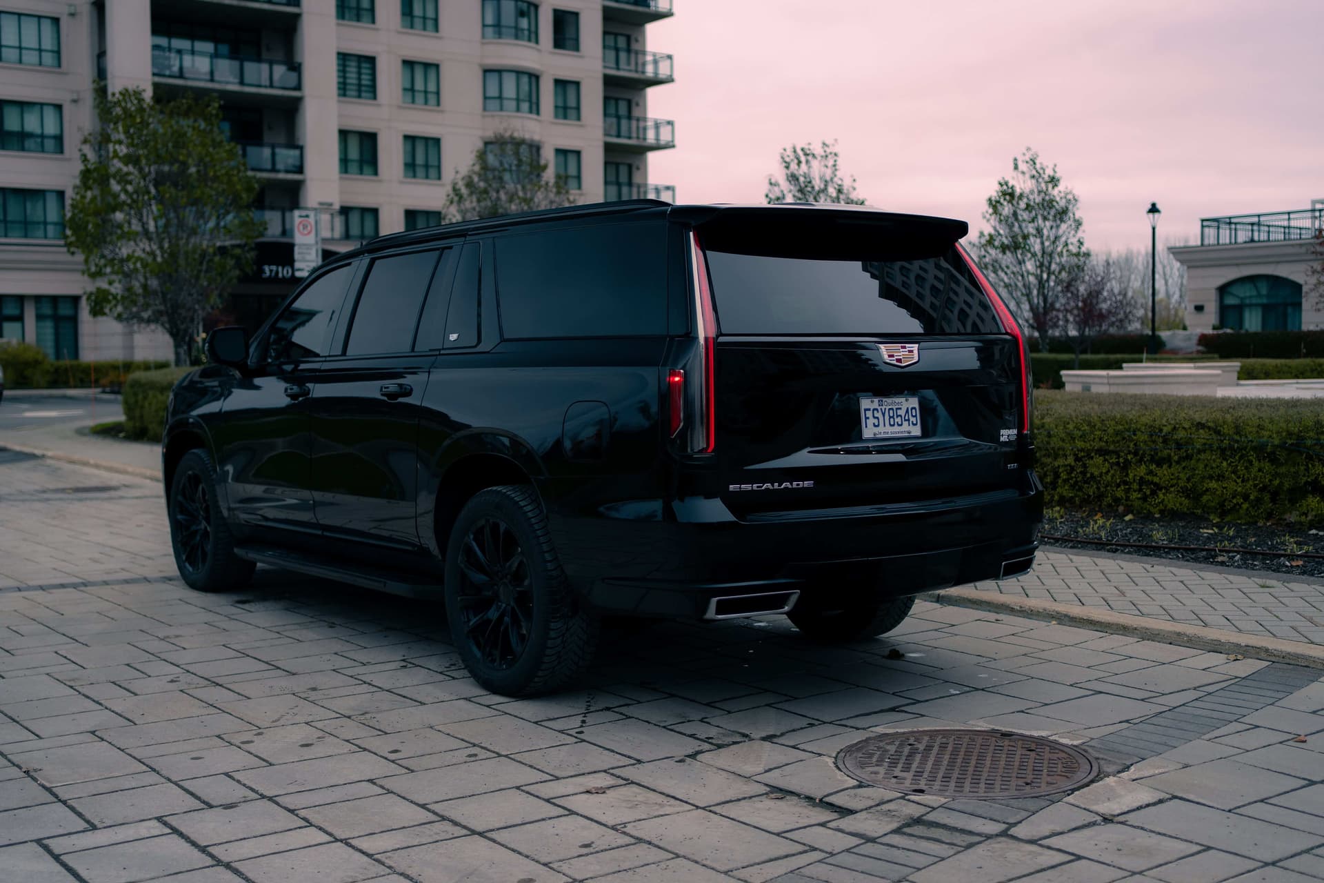 Black Cadillac Escalade ESV with vertical LED lights in a dark studio — photo 3