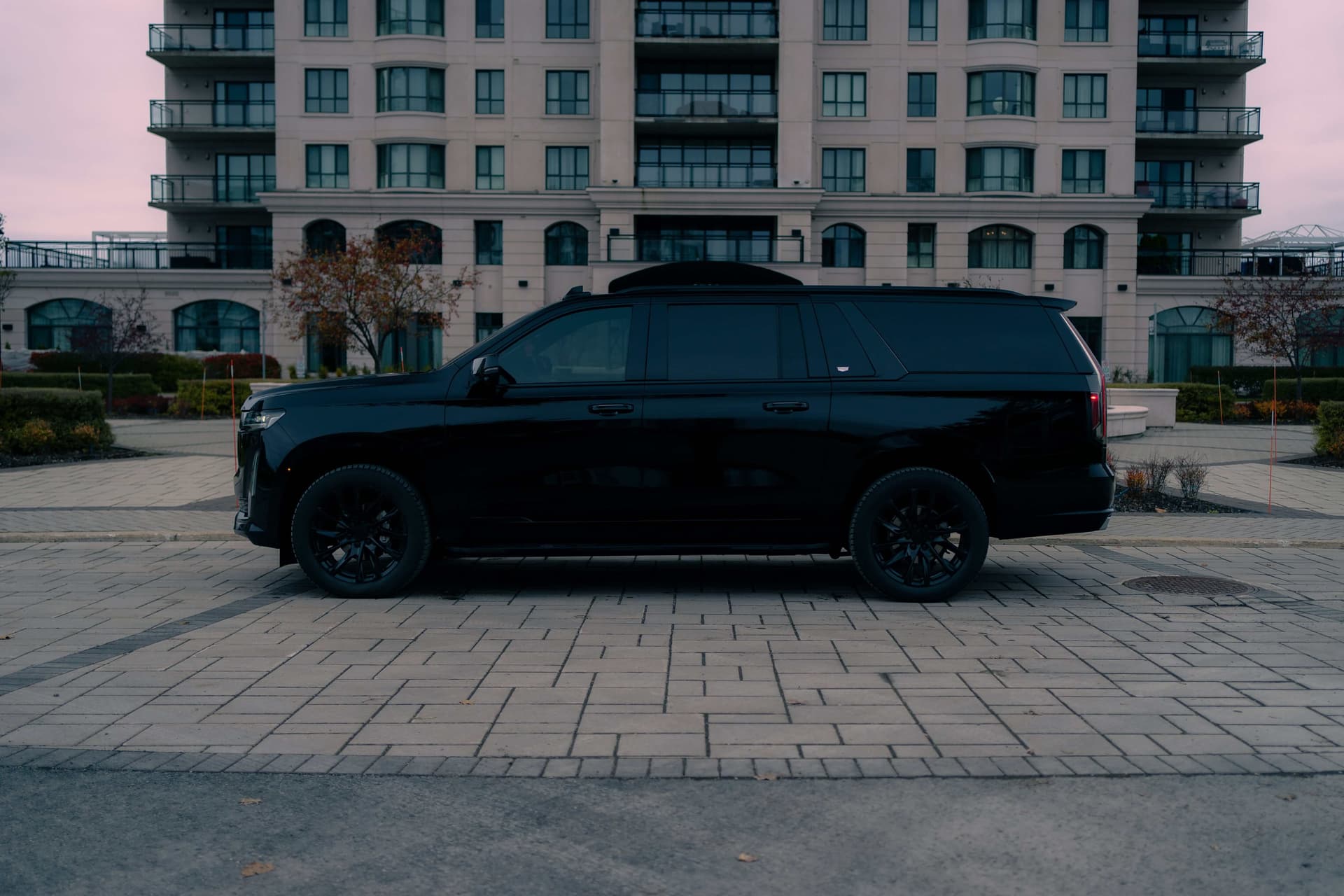 Black Cadillac Escalade ESV with vertical LED lights in a dark studio — photo 4