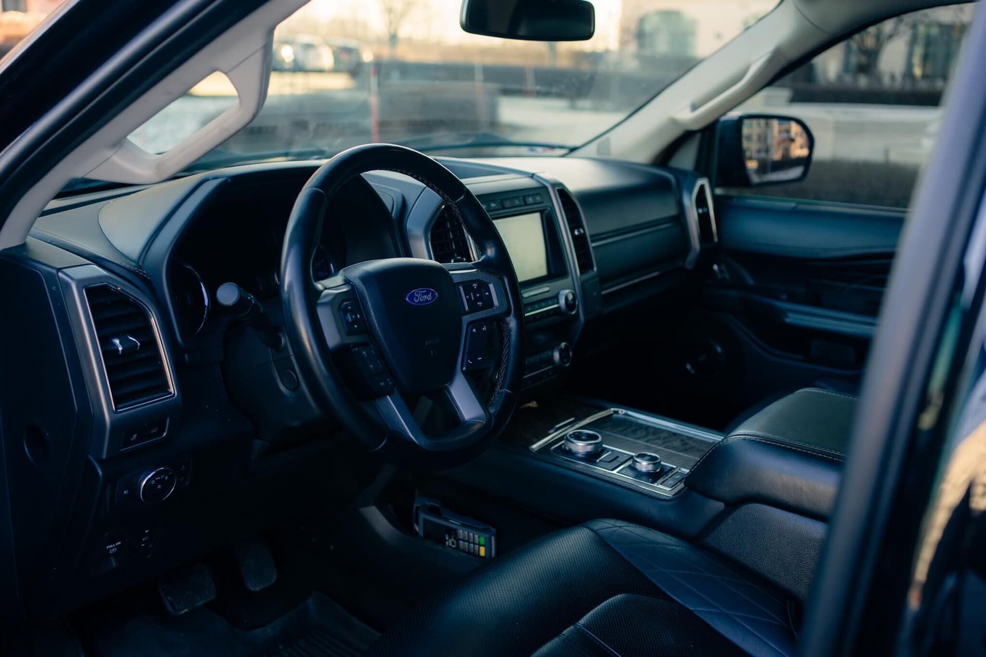 Black Ford Expedition Max in a dark studio with warm rim light — photo 2