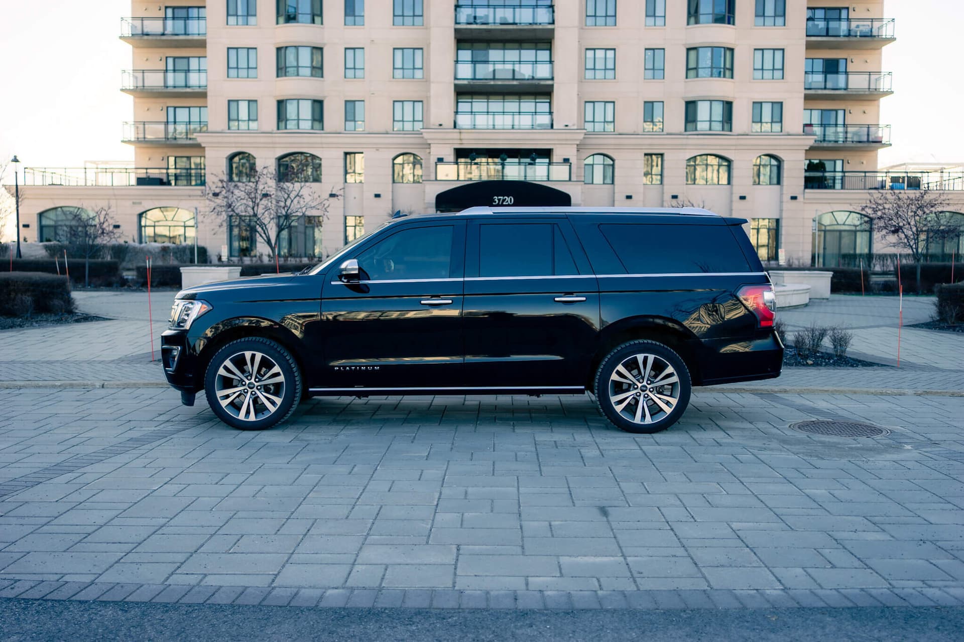 Black Ford Expedition Max in a dark studio with warm rim light — photo 4