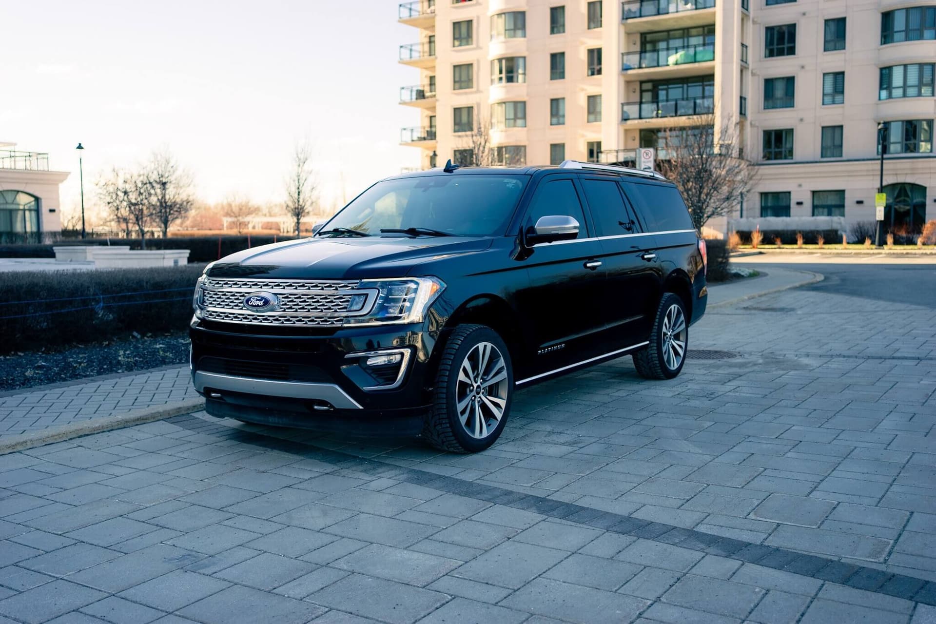 Black Ford Expedition Max in a dark studio with warm rim light — photo 5