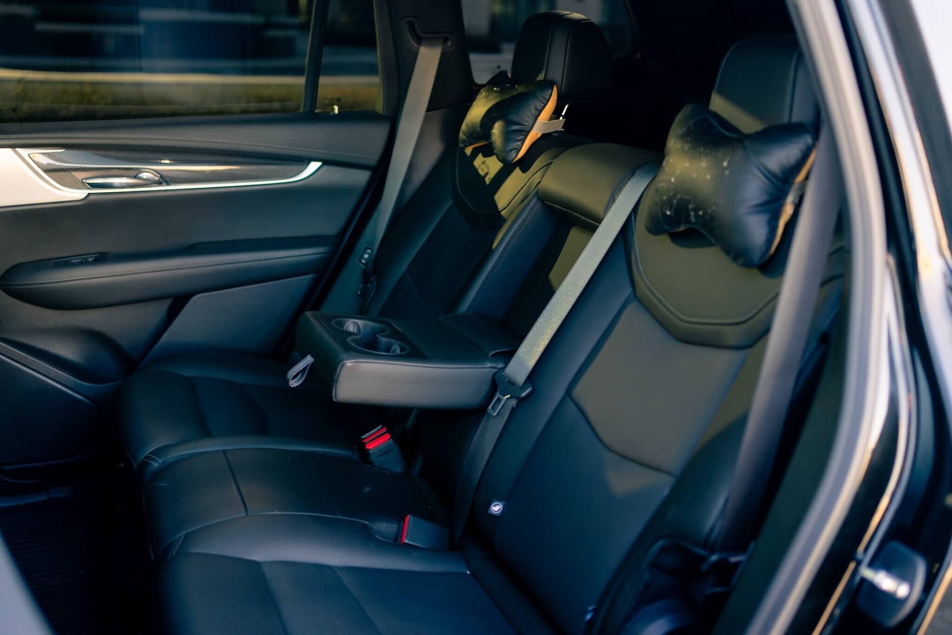 Black Cadillac XT6 luxury SUV in a dark studio with gold accents Black Cadillac XT6 luxury SUV in a dark studio with gold accents