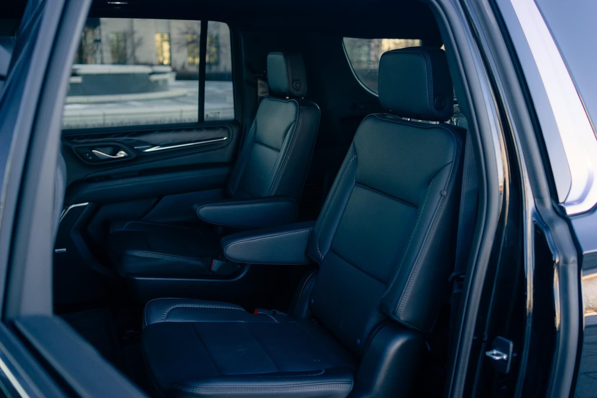 Black GMC Yukon XL on a dark reflective floor with golden edge light Black GMC Yukon XL on a dark reflective floor with golden edge light